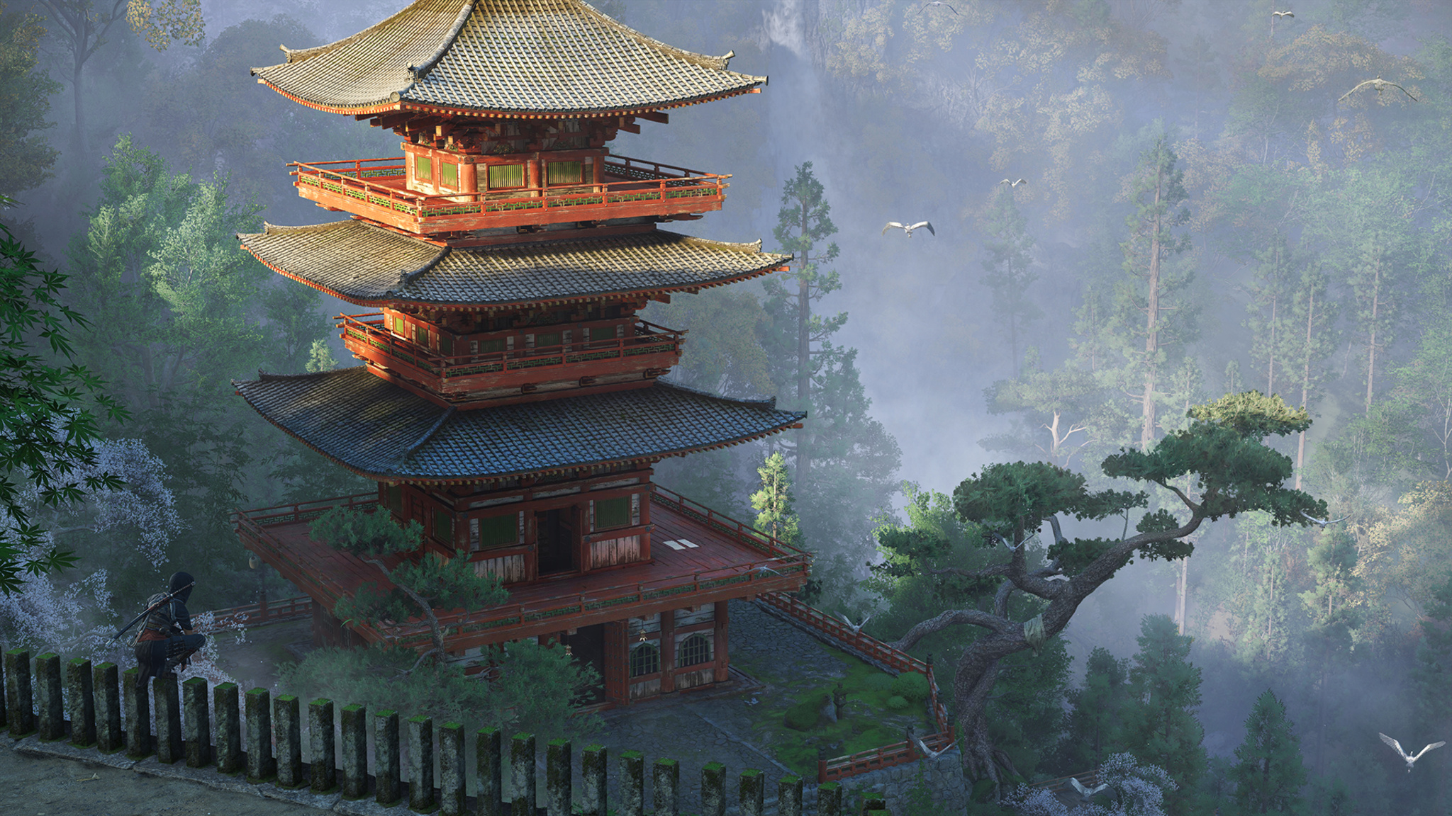 In this screenshot from Assassin’s Creed Shadows, a Japanese temple is seen in afternoon light. In the background is a misty forest.