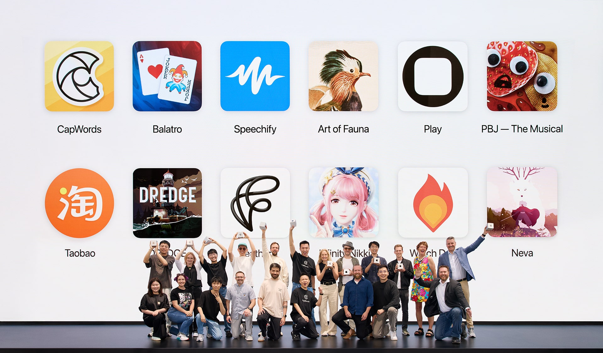 A photo of the 2025 Apple Design Award winners on stage at Apple Park. In the background is a large video screen.