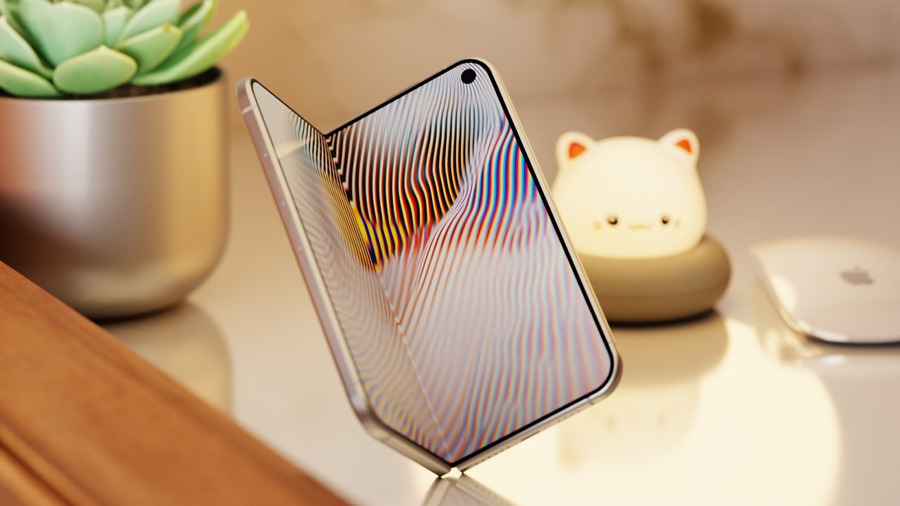 Foldable smartphone standing partially open on a wooden desk, displaying colorful wavy lines, with a small potted succulent, a glowing cat-shaped night light, and computer mouse nearby