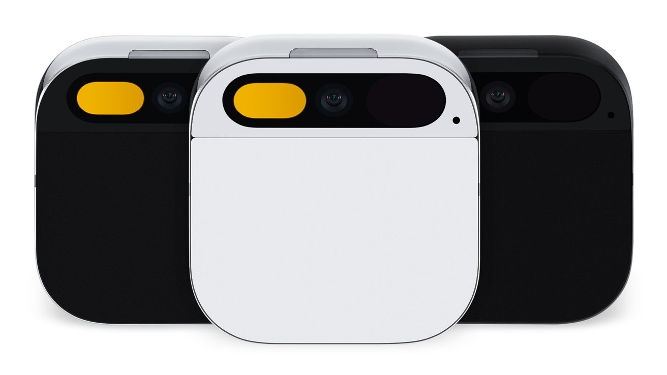 Three small square wearable camera devices, one white in front and two black behind, each with rounded corners and a horizontal pill-shaped lens area featuring a yellow accent on the left